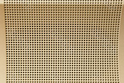 Metallic light golden perforated background