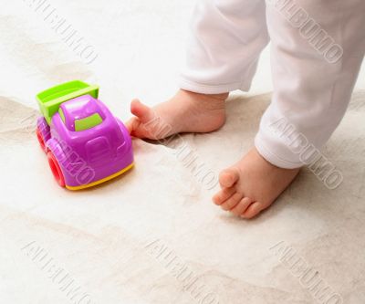 Baby`s foot and toy