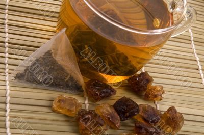 white tea, nylon tea-bag and golden sugar