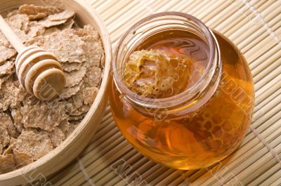 fresh honey with honeycomb and breakfast flakes