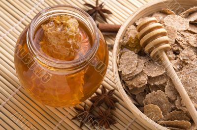fresh honey with honeycomb, spices and breakfast flakes
