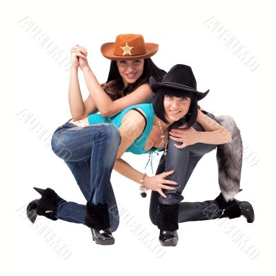 cowgirls in jeans, boots and cowboy hat
