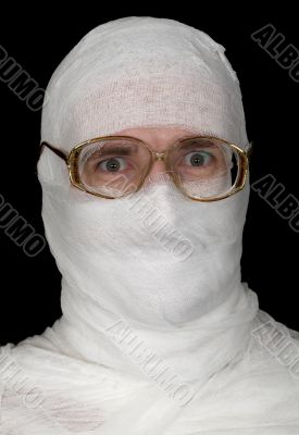 Guy rolled up by bandage in spectacles