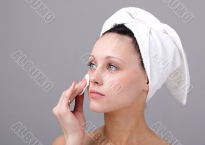 woman cleaning face