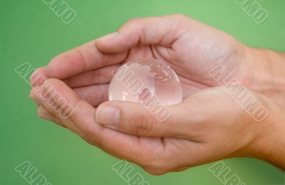Hands with glass globe