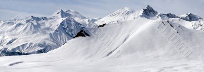 Snowy mountains in clouds with an interesing tints