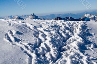 Deep footprints on the snow in the mountains