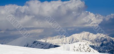 Snowy mountains in clouds with an interesing tints amd shadows
