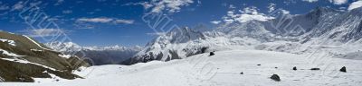 The picturesque mountain view with clouds, peaks and snow valey