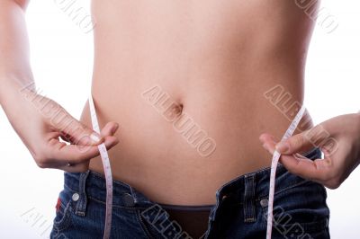 Woman measuring her waist