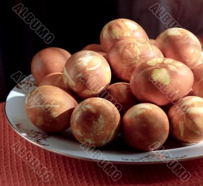 Painted pasch-eggs on white plate