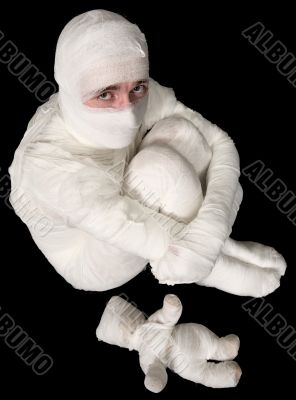 Egyptian mummy emo sitting on a black