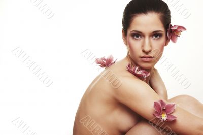 Beautiful young woman with orchid flowers