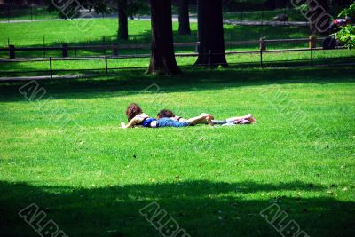 Friends relaxing on green grass