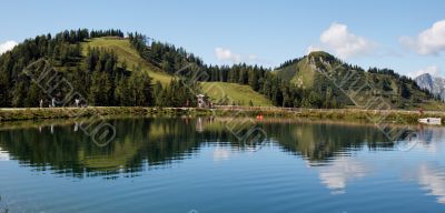 Two hills reflecting in pond