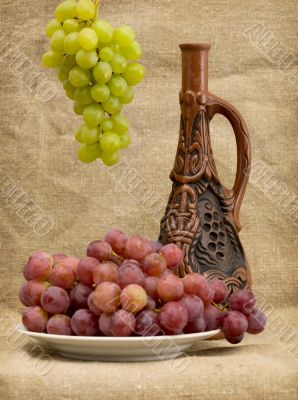 Grapes and wine in bottle