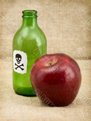 Bottle with poison and an apple