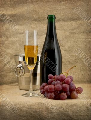 Glass of wine and a champagne bottle