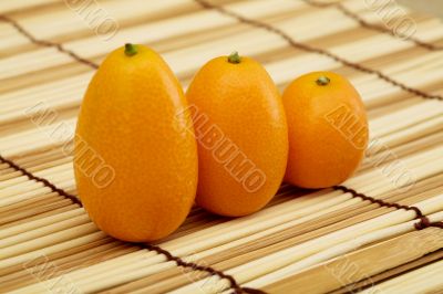 Fresh kumquat against a mat