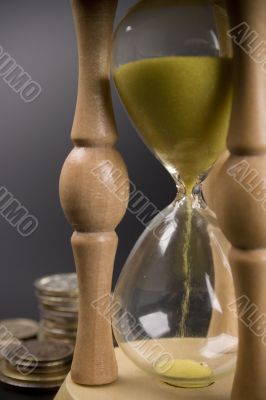 sand clock and coin