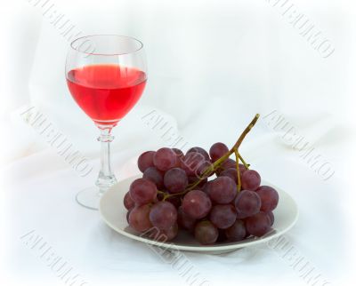 Still-life with a glass of red wine and grapes