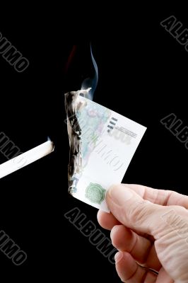burning money with cigarette