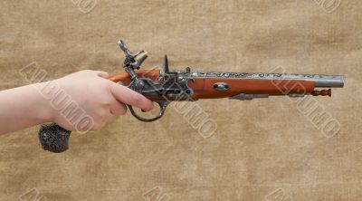 Ancient pistol in female hand