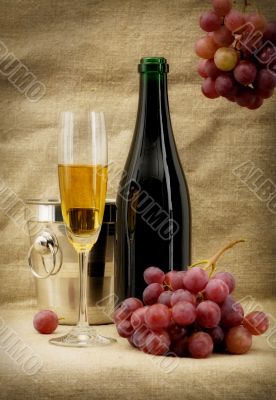 Champagne bottle, bucket, goblet and grapes