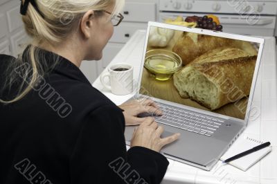 Woman In Kitchen Using Laptop - Food and Recipes