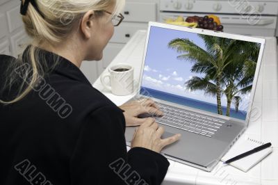 Woman In Kitchen Using Laptop - Vacation