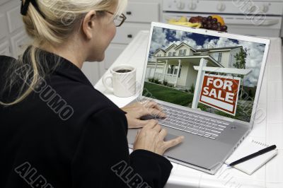Woman In Kitchen Using Laptop for Real Estate