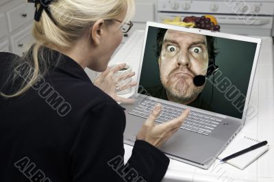 Excited Woman In Kitchen Using Laptop