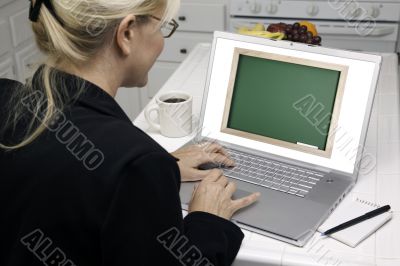 Woman In Kitchen Using Laptop - Chalkbaord