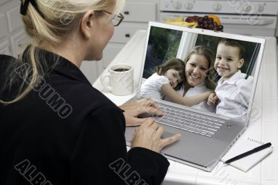 Woman In Kitchen Using Laptop - Family and Friends
