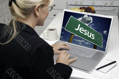 Woman In Kitchen Using Laptop