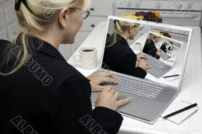 Abstract of Woman In Kitchen Using Laptop