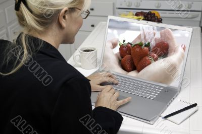 Woman In Kitchen Using Laptop - Food and Recipes