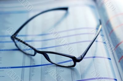 glasses on newspaper page