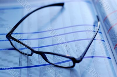 glasses on newspaper page