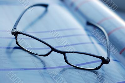 glasses on newspaper page