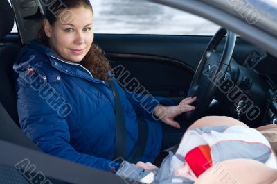 Mother and child in car safety seat