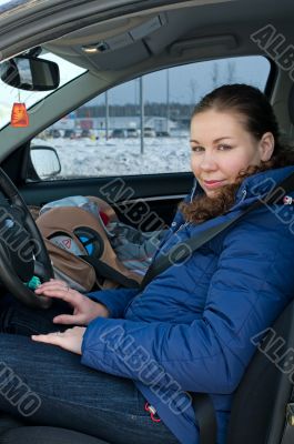 Mother and child in safety seat