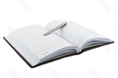 Close up noutbook and pen on it isolated over white