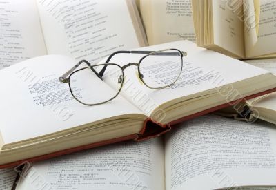 Many books and glasses on it