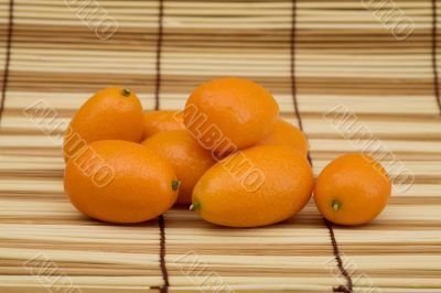 Fresh kumquat against a mat