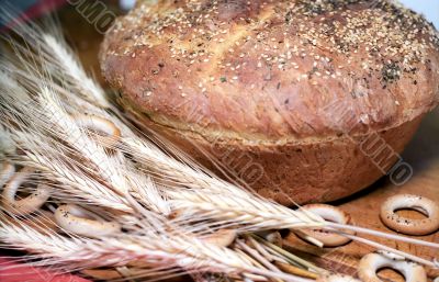 Loaf of bread with biscuits and wheatears