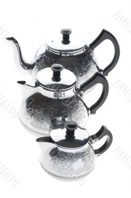 Three metal teapot on white
