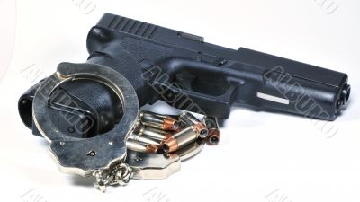 Handgun with handcuffs and bullets