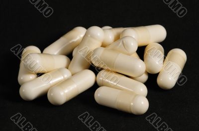 White capsules on a black background