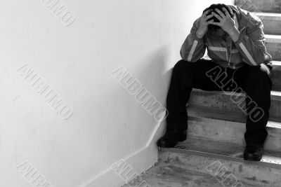 Frustrated man sitting on steps